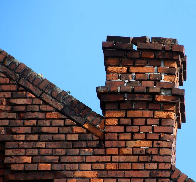 Damaged chimney on an Harvard home showing cracks and missing mortar